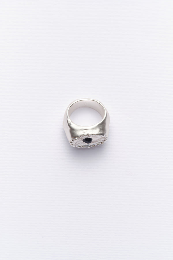 Silver sculptural signet ring with black stone front view