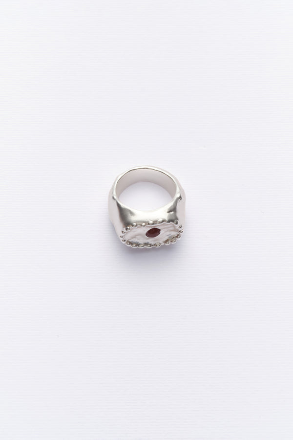 Silver sculptural signet ring with red stone front view