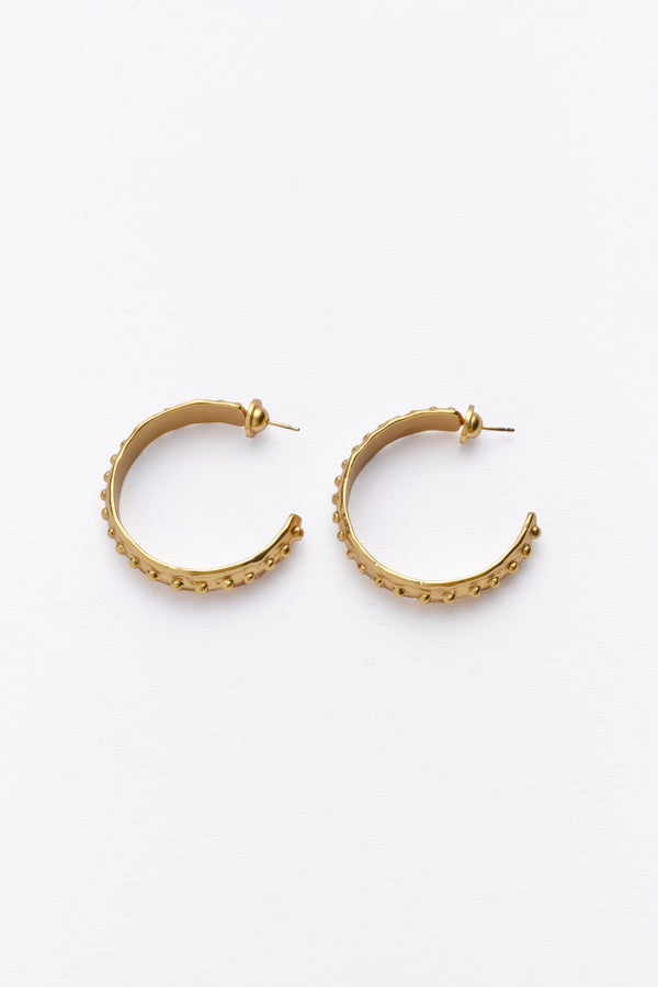 Gold textured hoop earrings with beaded edge flat lay