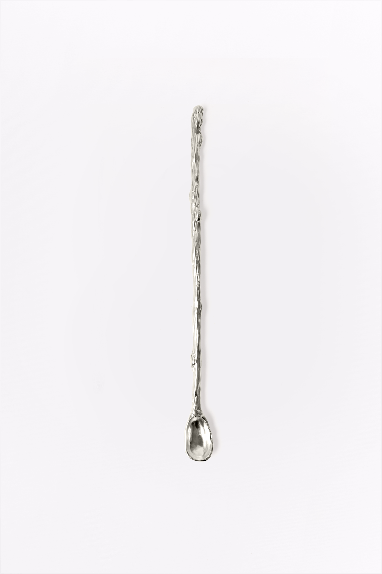 Silver mixing spoon on a white background