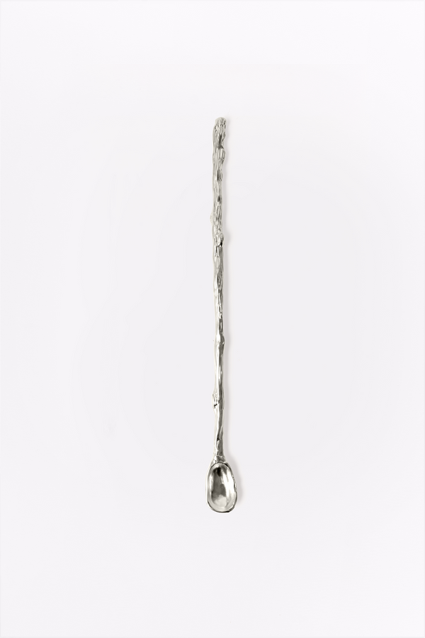 Silver mixing spoon on a white background