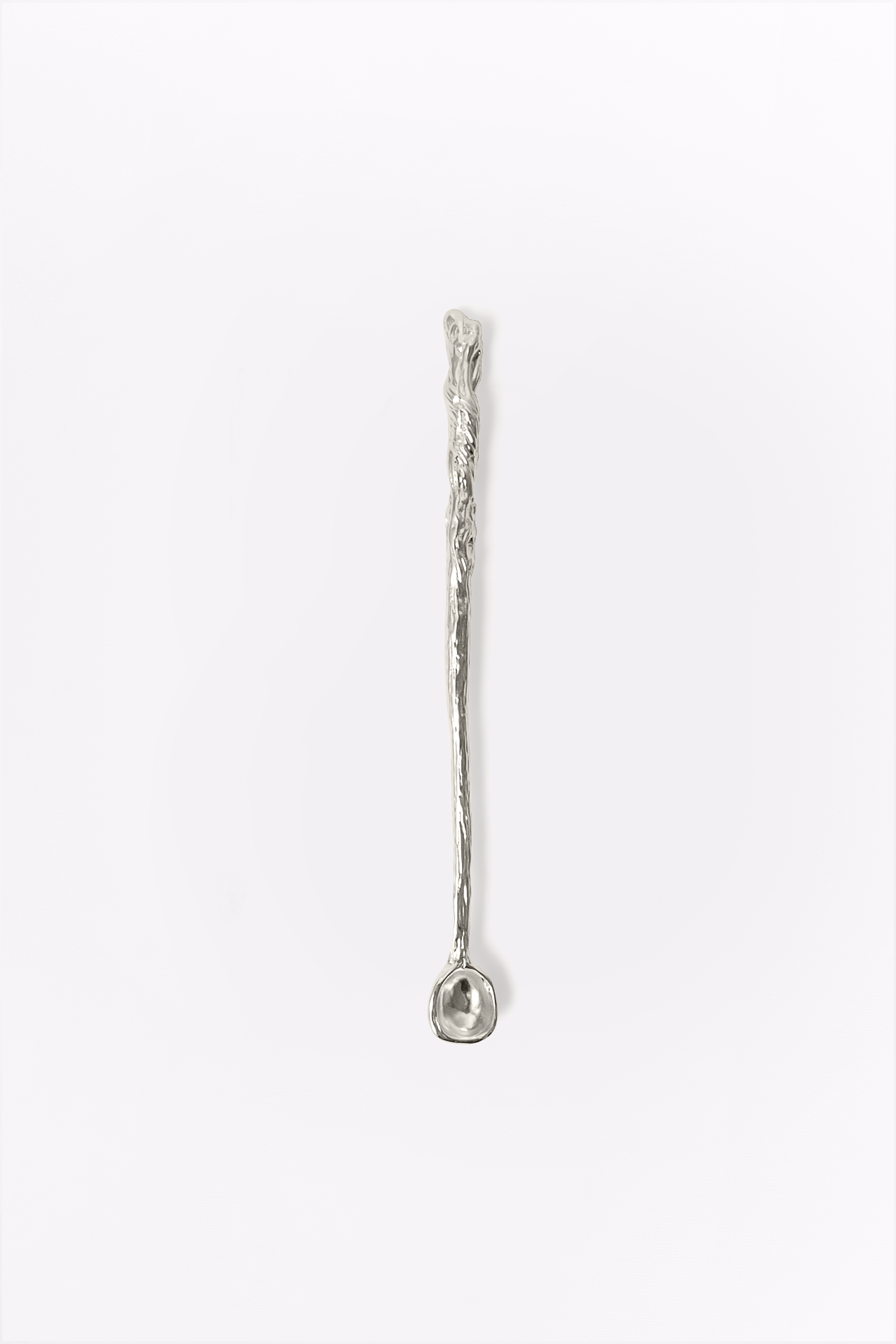Silver spoon with textured handle on a white background