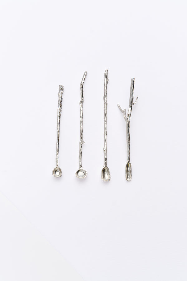 A set of four silver stirring sticks with varying designs, displayed against a white background.