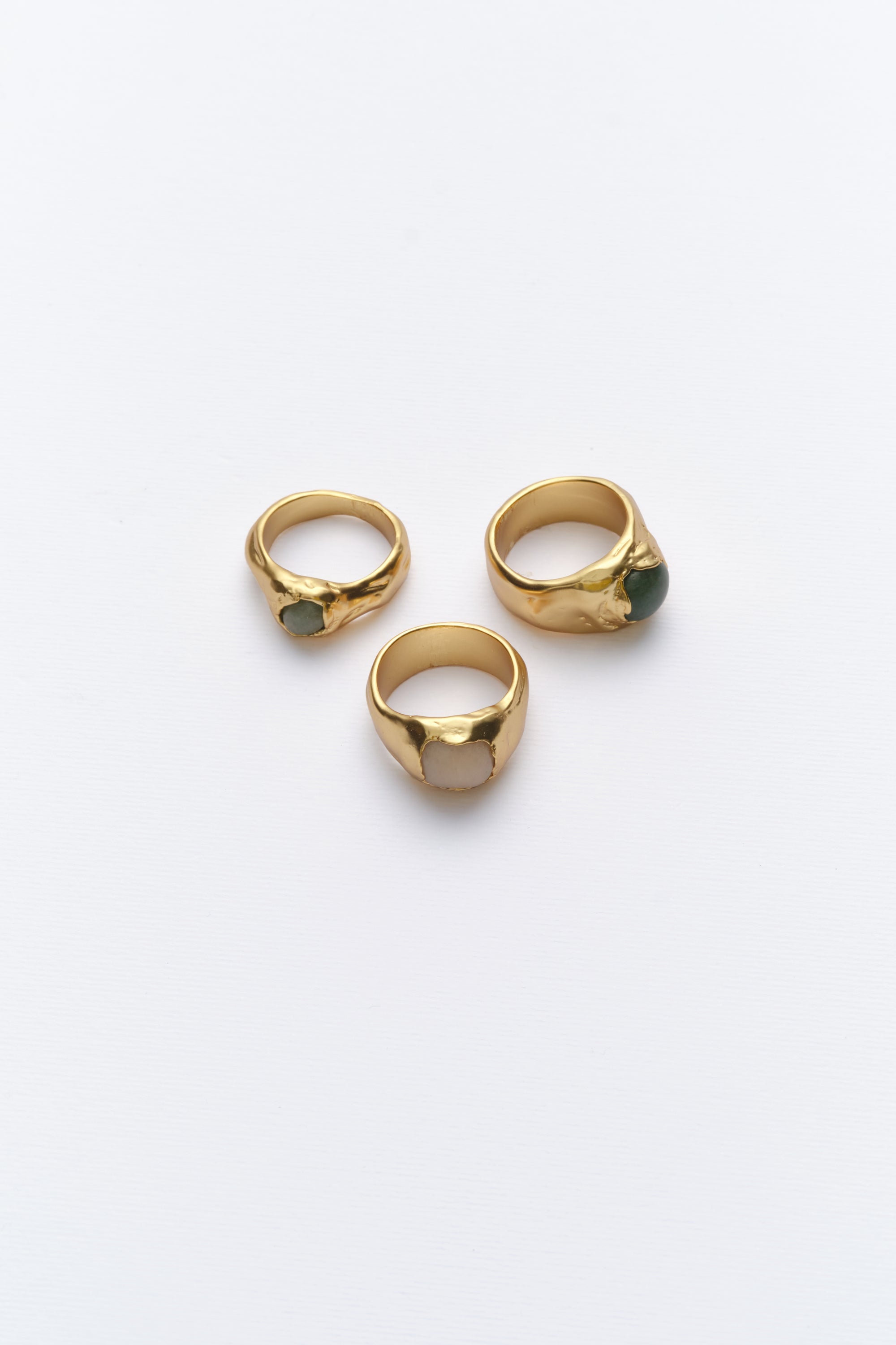 Gold organic signet rings with natural gemstones flat lay