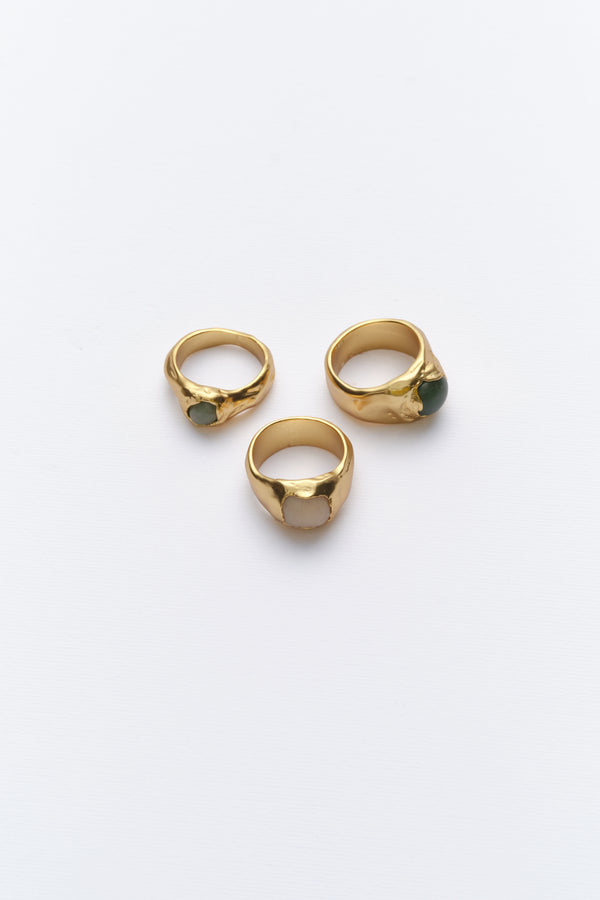 Gold organic signet rings with natural gemstones flat lay