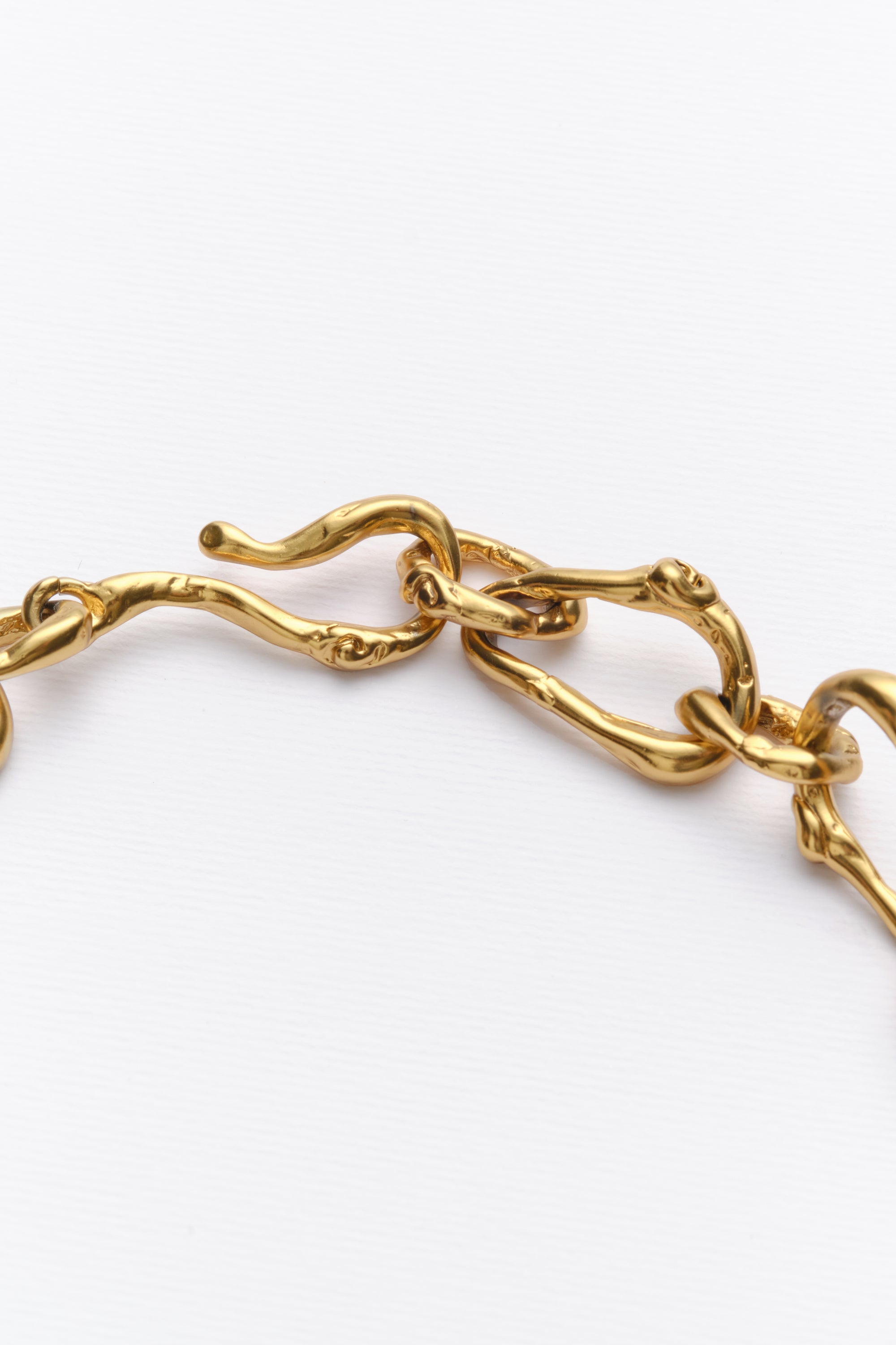 Gold sculptural chain bracelet link detail
