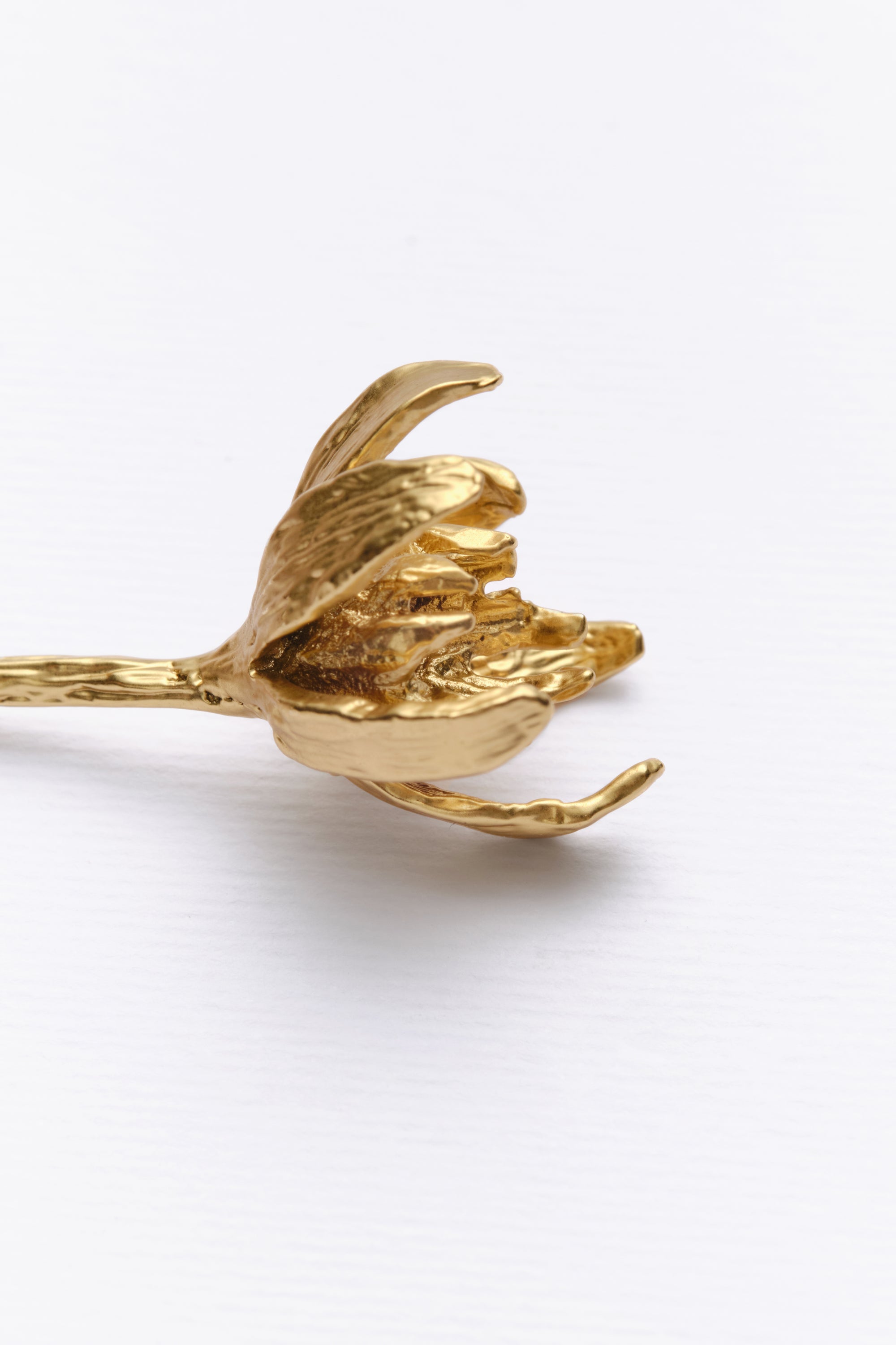 Gold sculptural flower bracelet detail side view