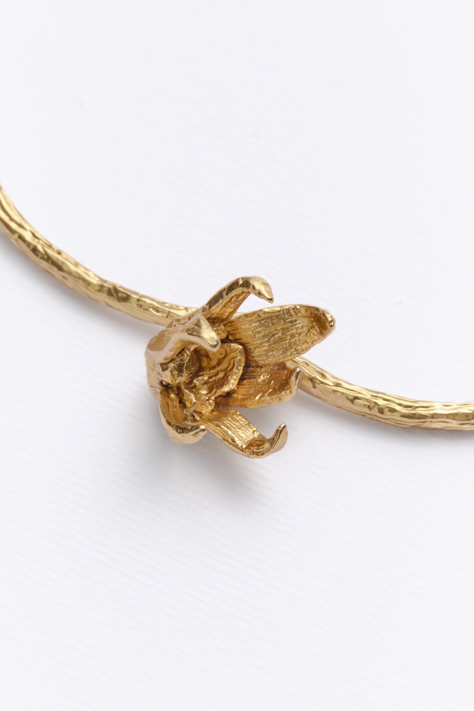 Gold sculptural flower bracelet top detail view