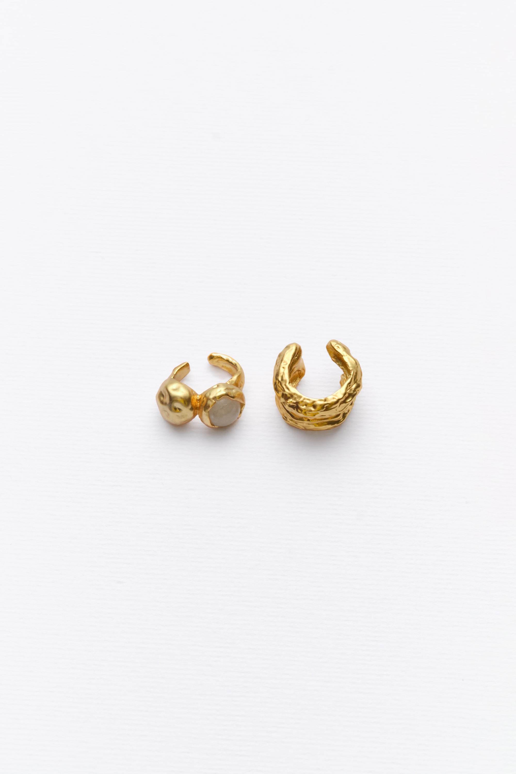 Gold sculptural ear cuff and stone ear cuff flat lay