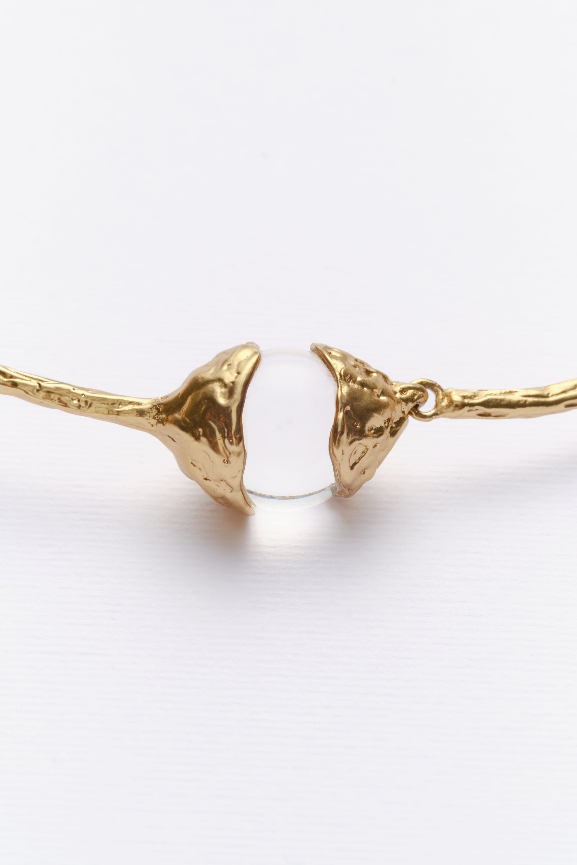 Gold sculptural collar necklace clasp detail