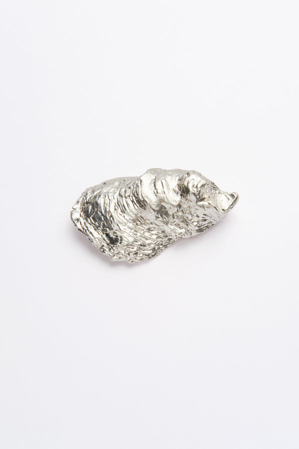 A silver incense holder crafted in the shape of an oyster with a high shine finish, displayed against a white background.