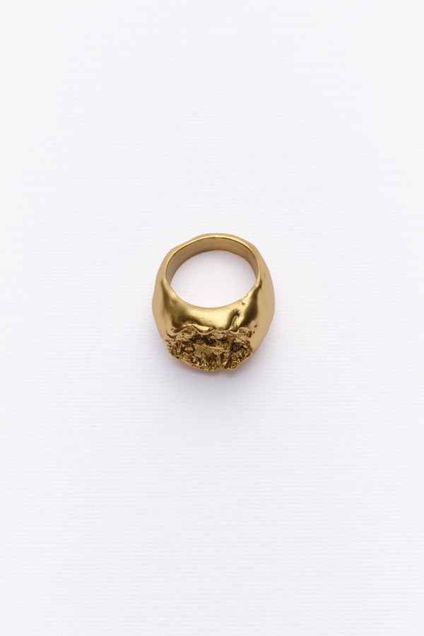 Bold textured gold statement ring with organic design on clean white background