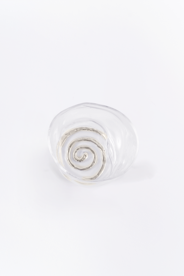 Clear glass knob with spiral coaster on a white background