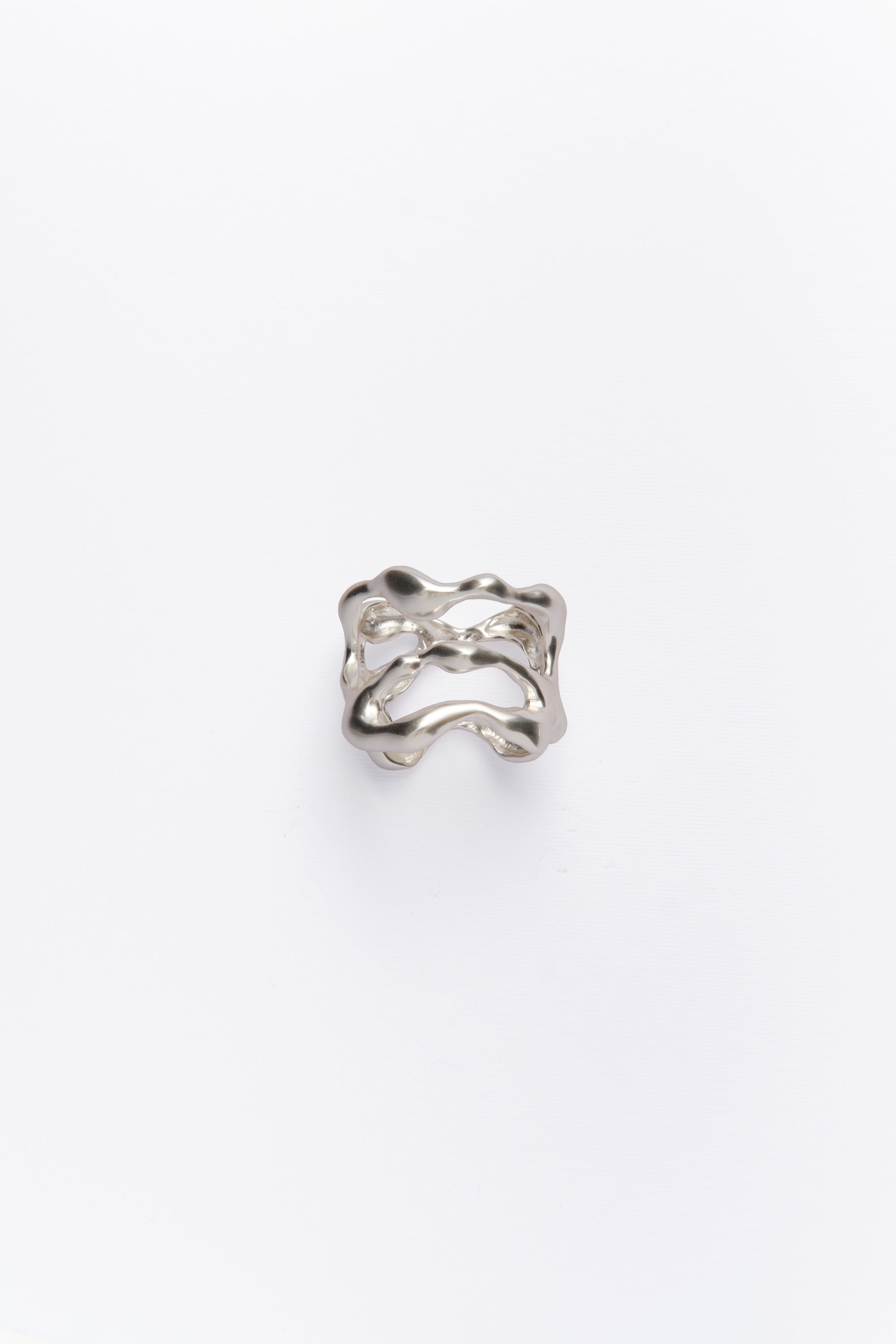 A silver napkin ring with an organic shape design, featuring ion plating.