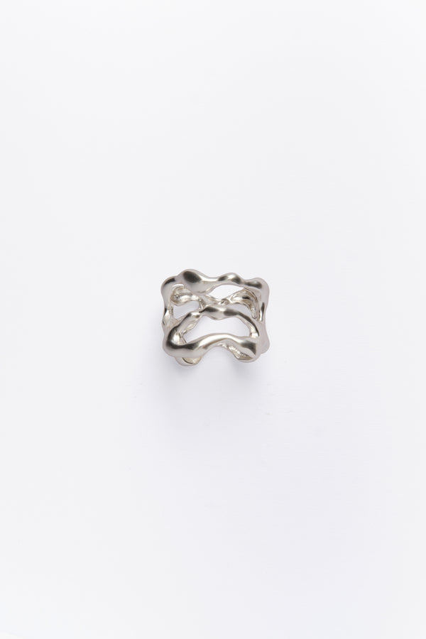 A silver napkin ring with an organic shape design, featuring ion plating.