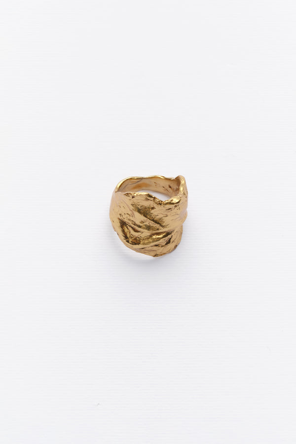 A silver ring with a natural leaft texture, displayed against a white background.