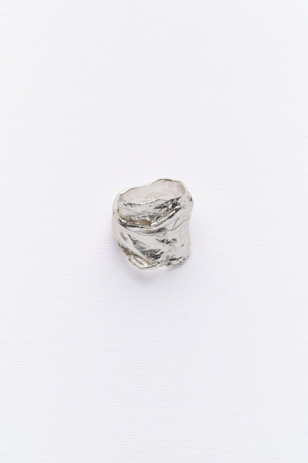 A silver ring with a natural leaft texture, displayed against a white background.