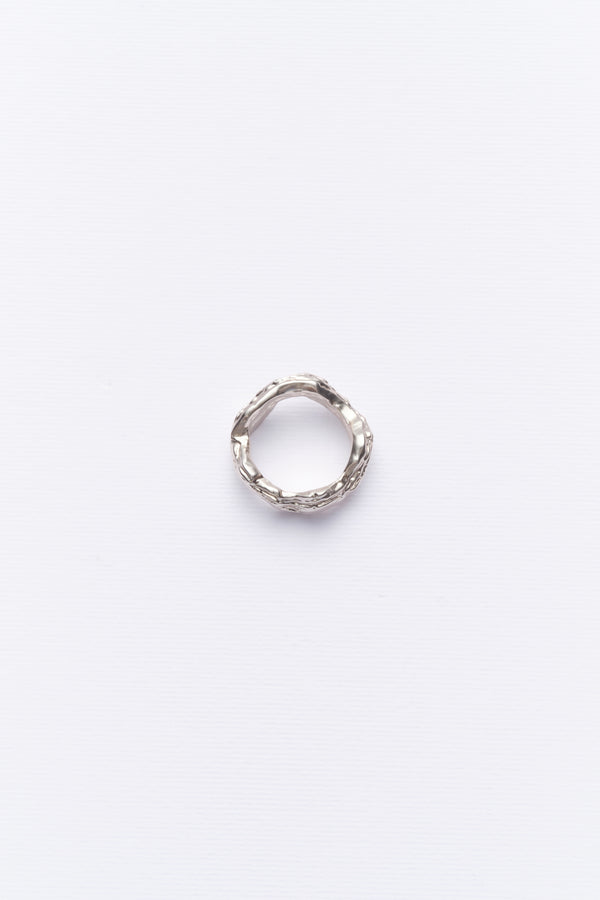Minimalist textured silver ring displayed on clean white background