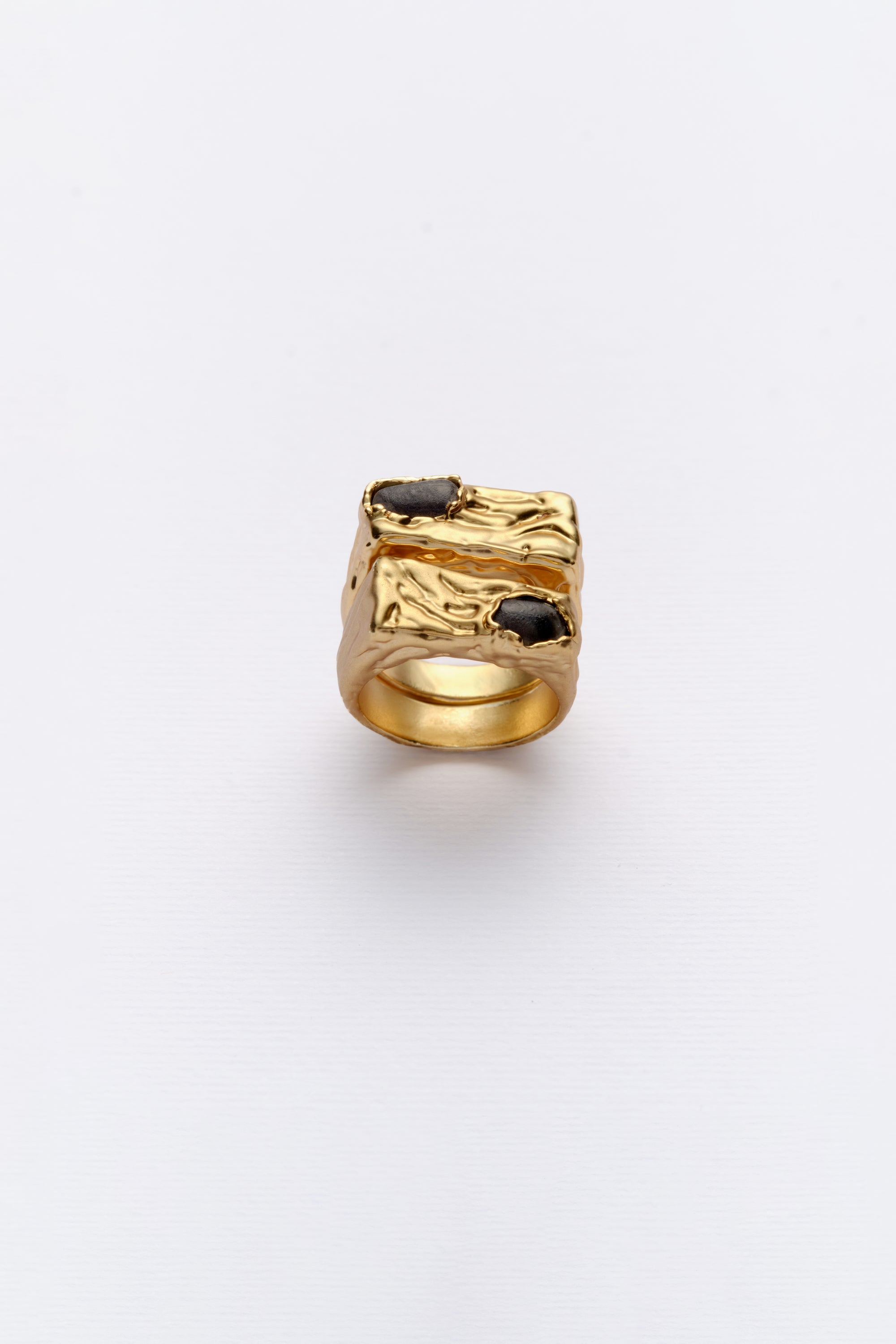 Gold textured signet ring with dark stone front view