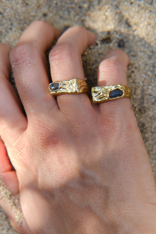 Gold textured signet rings worn on hand close-up