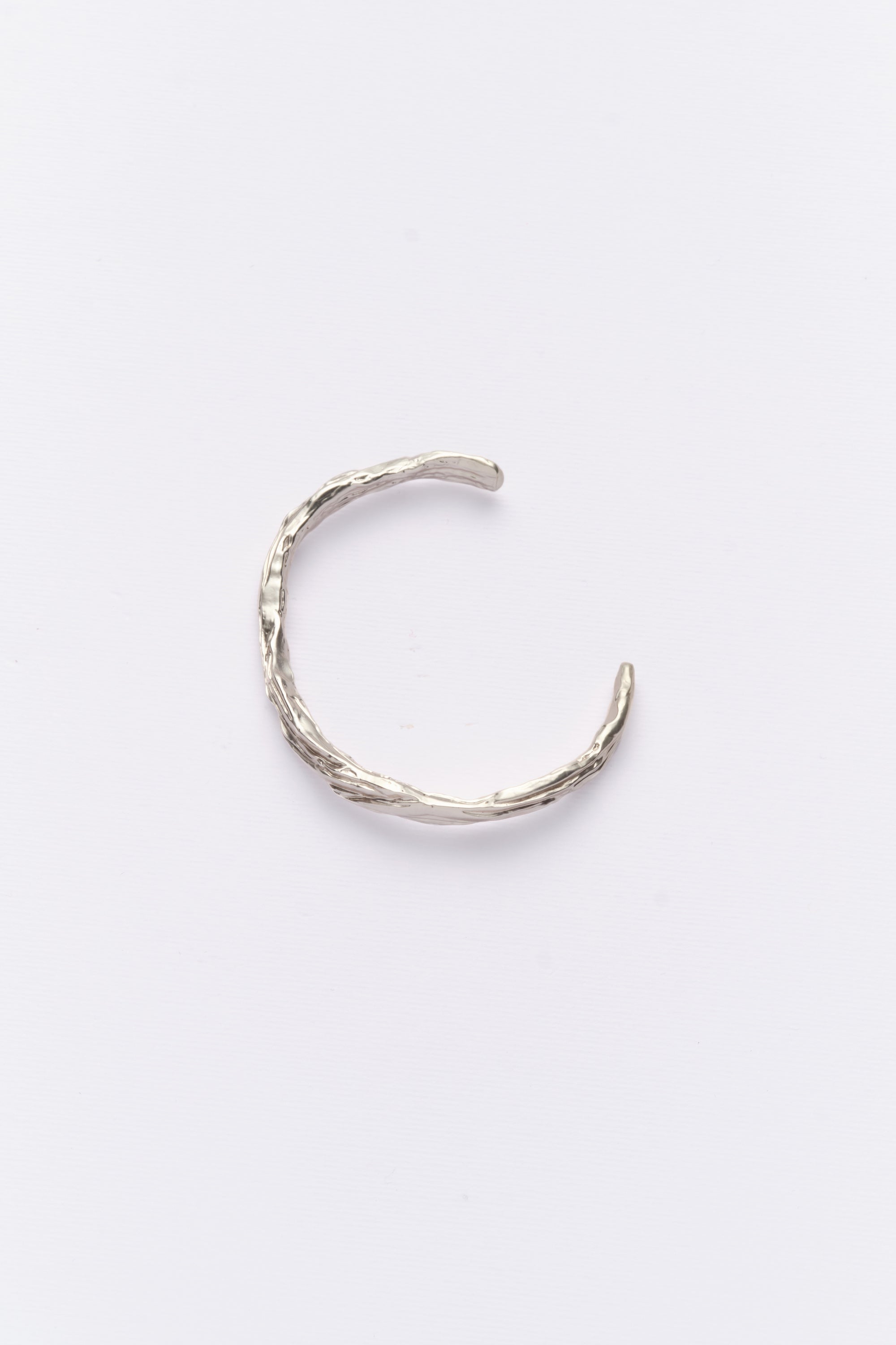 Silver organic open cuff bracelet flat lay