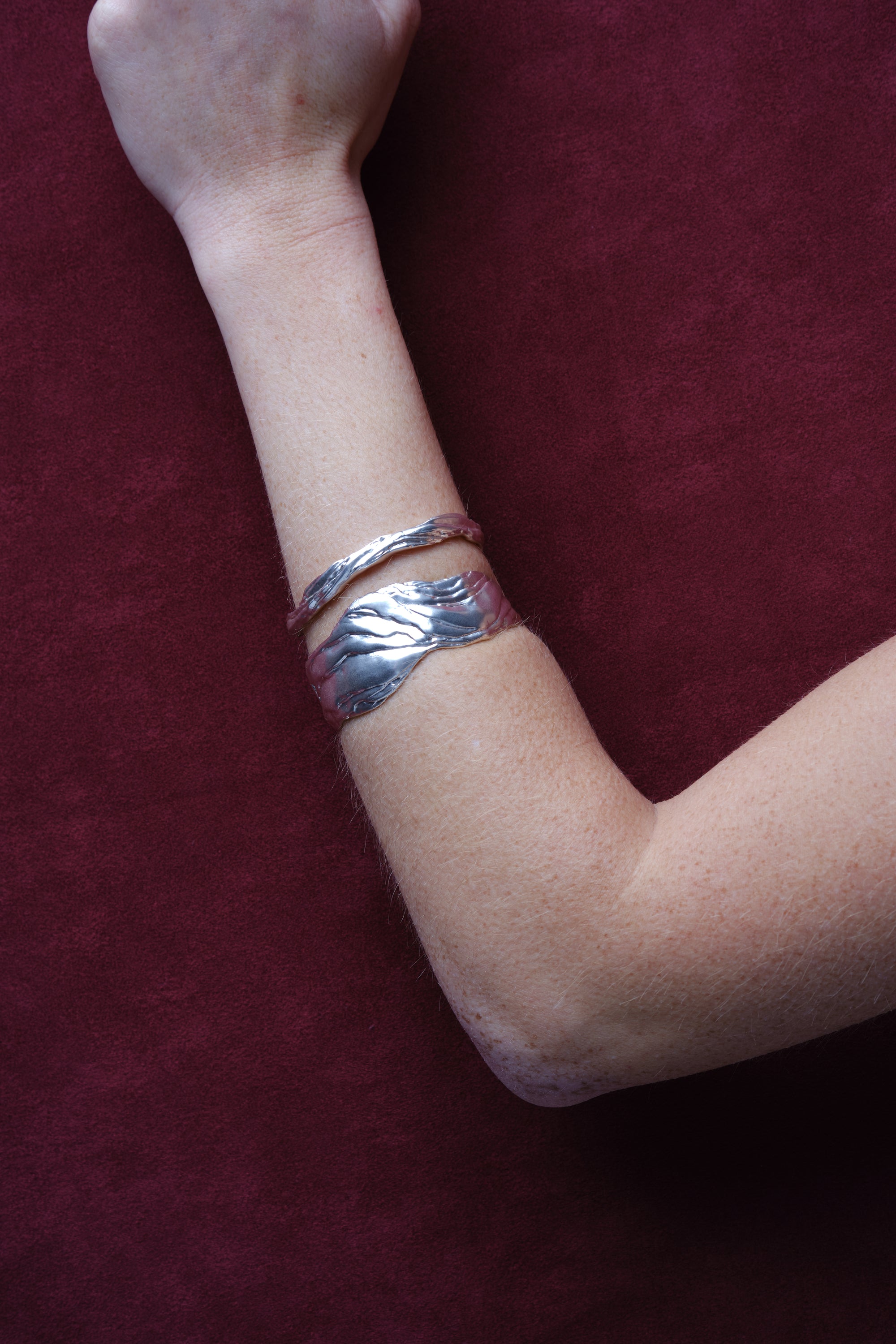 Silver sculptural cuff bracelet worn on arm