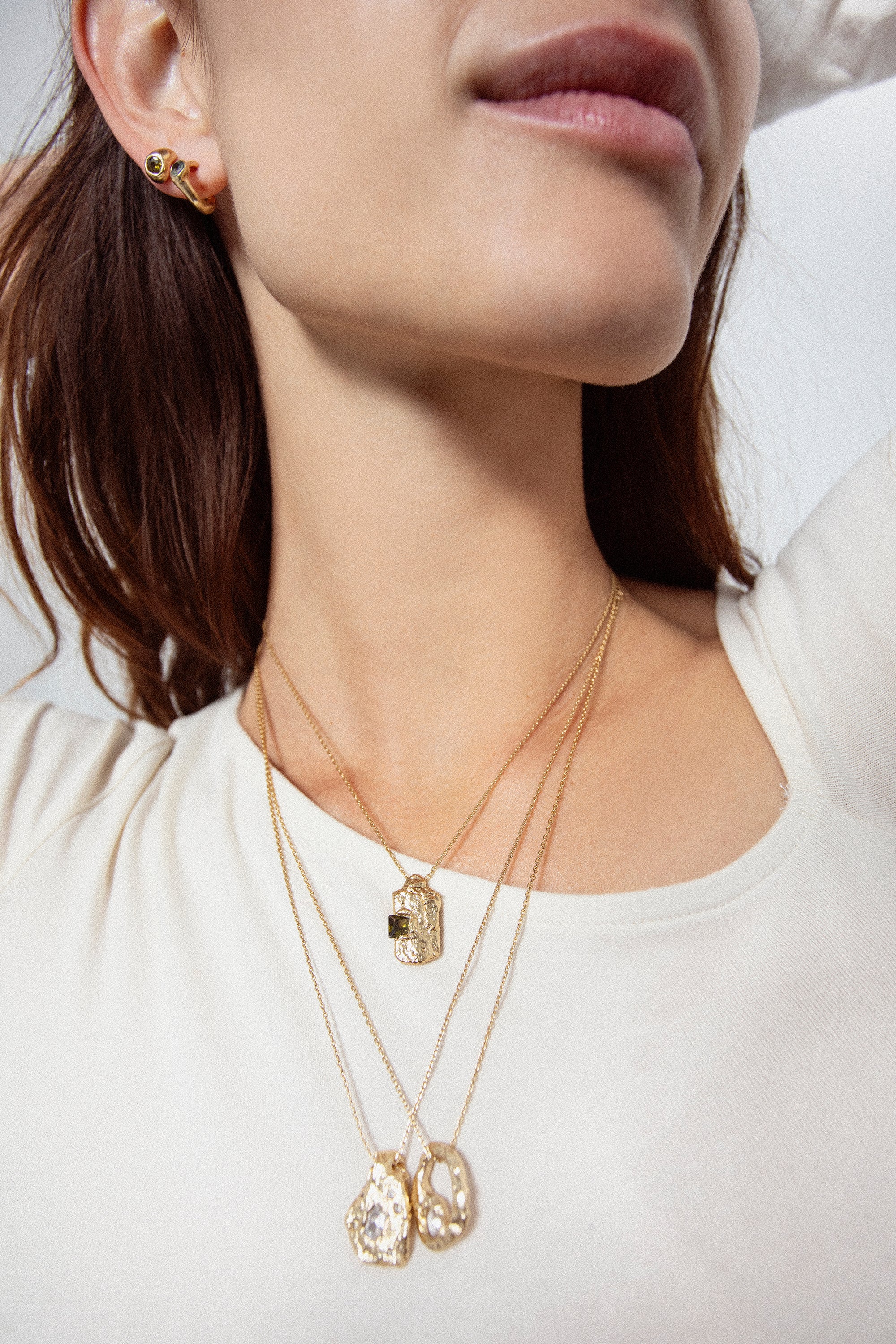 Layered gold textured rectangular pendant necklace on model