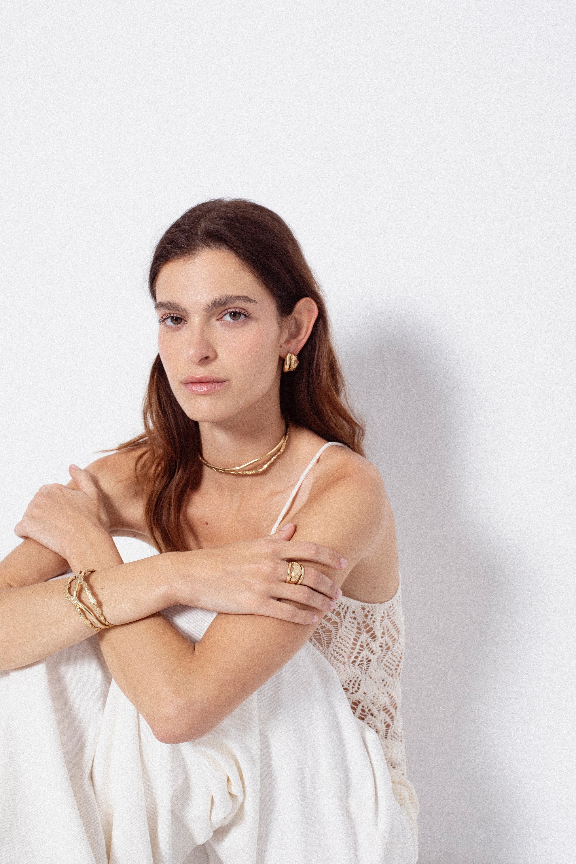 Model styling sculptural gold choker necklace as a statement piece