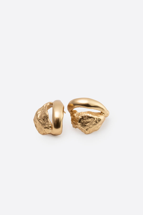 Sculptural gold stud earrings with organic texture on white background