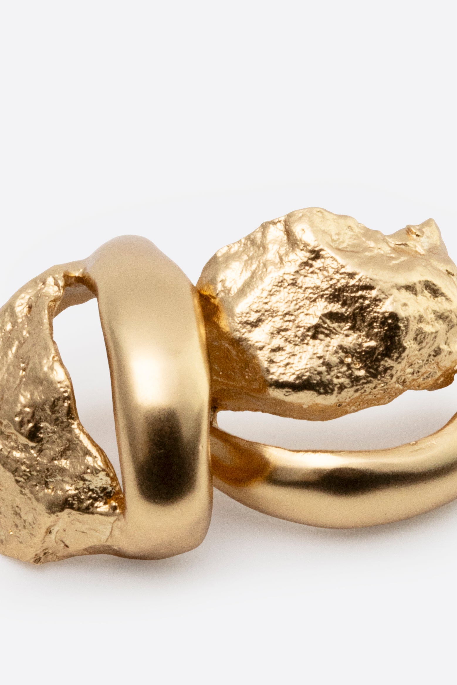 Gold statement stud earrings with organic rock-inspired design