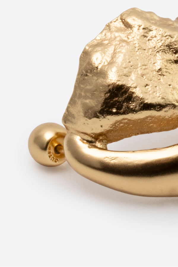 Close-up of gold stud earring back and post detail