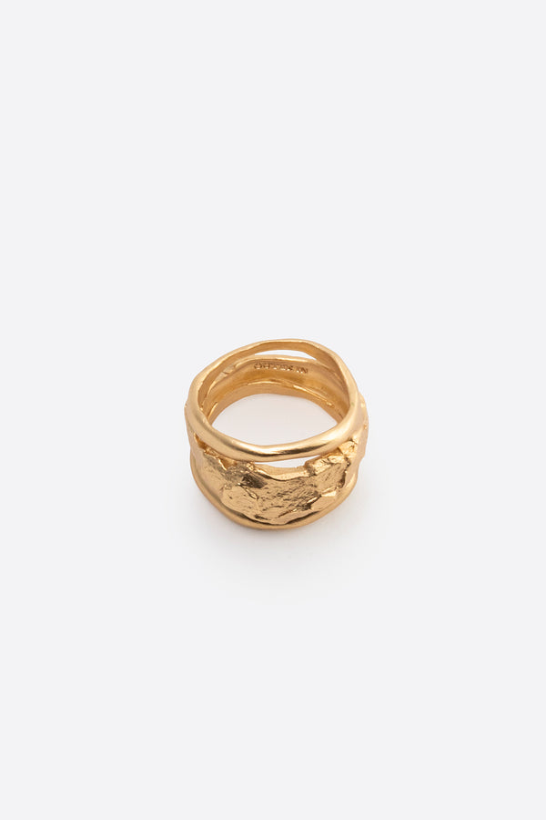 Sculptural gold statement ring with organic texture on white background