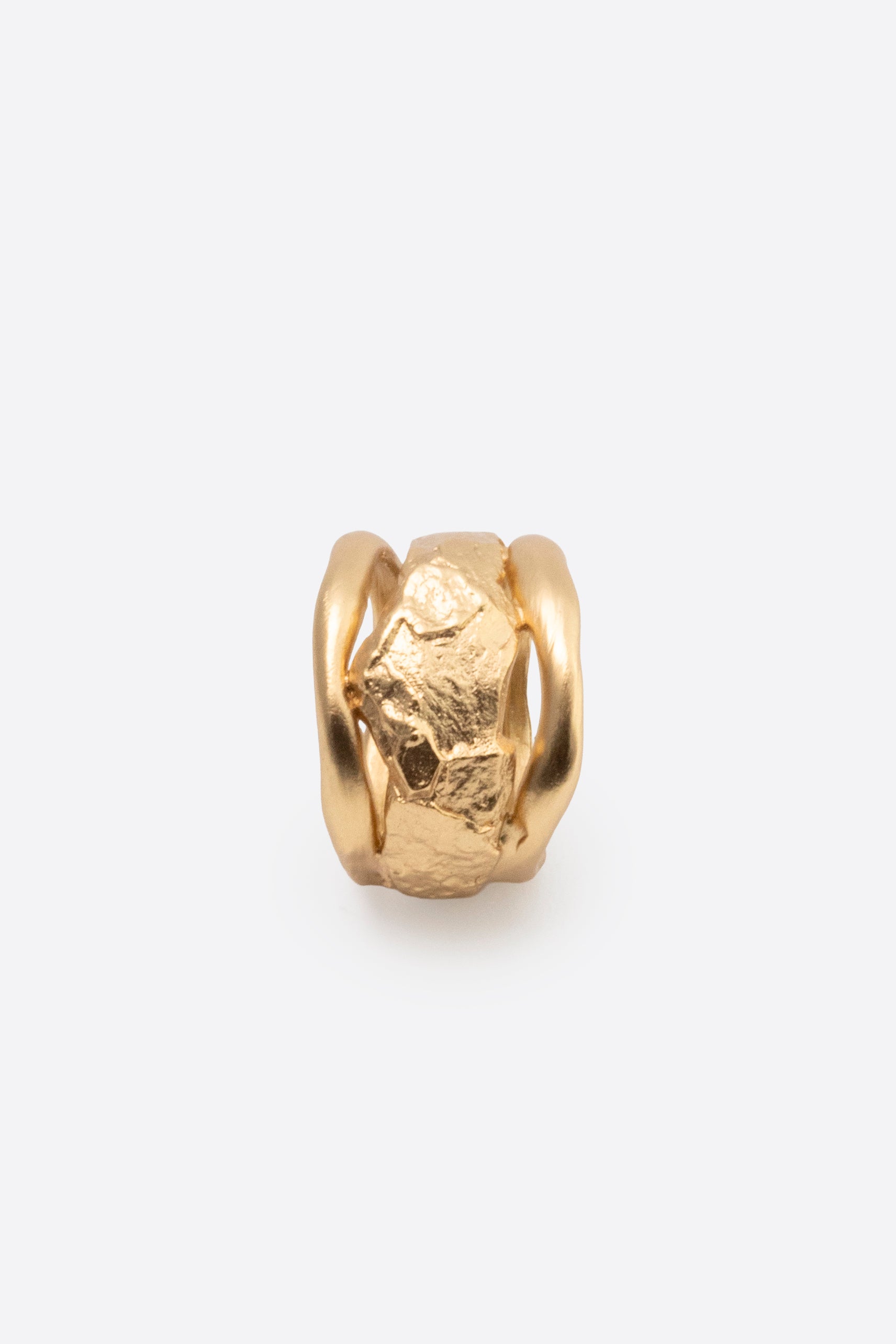 Side view of sculptural gold statement ring with textured organic design