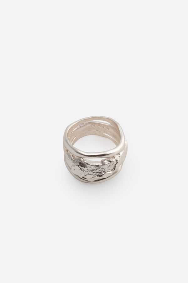 Sculptural silver statement ring with organic texture on white background