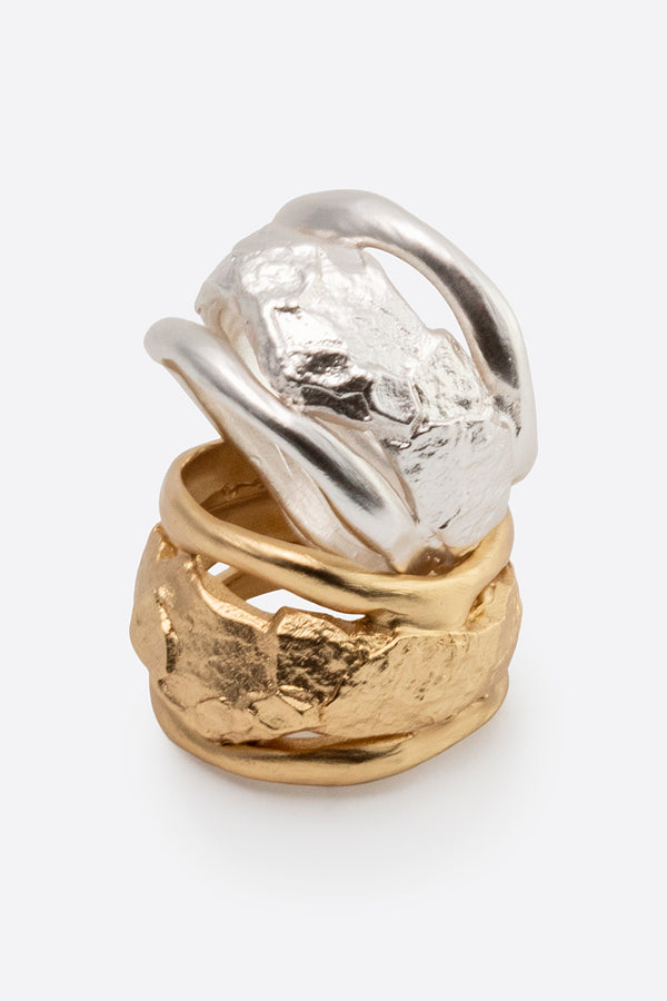 Silver and gold sculptural statement rings with organic texture