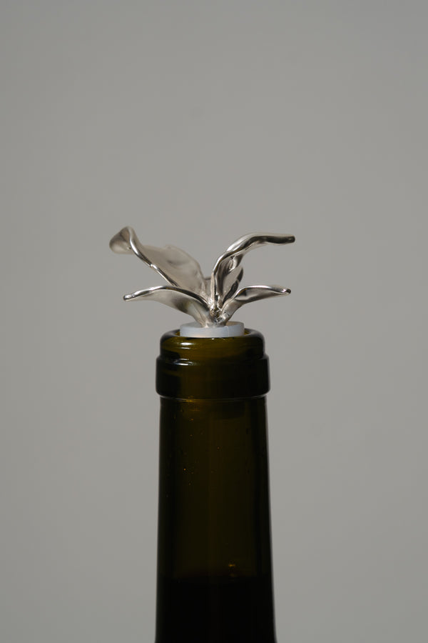 Silver sculptural bottle stopper on wine bottle