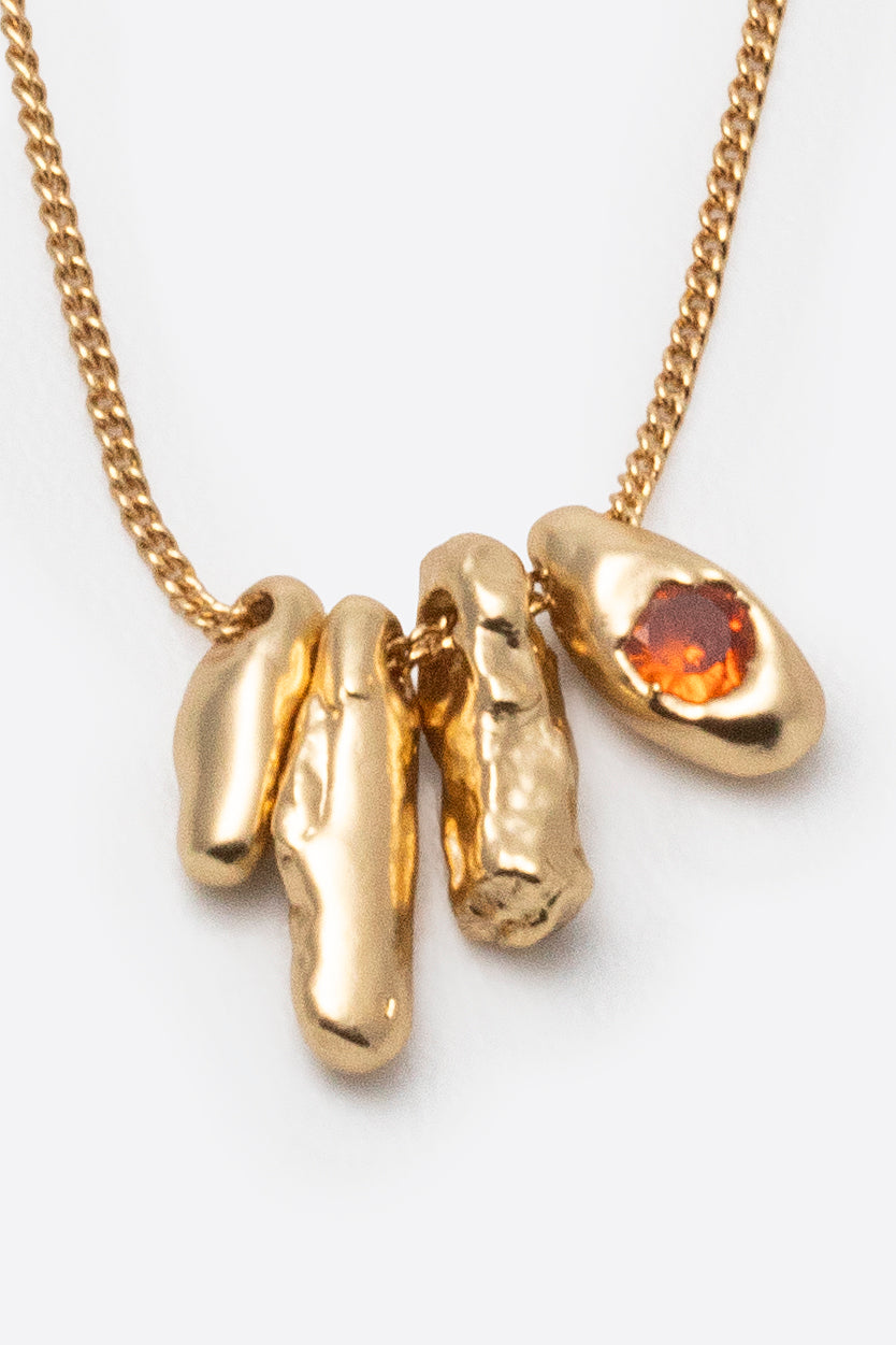 Sculptural gold gemstone pendant necklace on fine chain