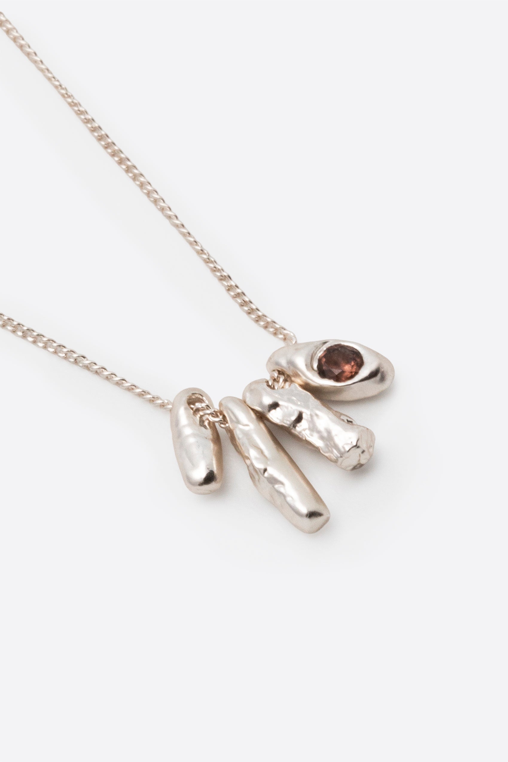 Silver gemstone pendant necklace with organic sculptural charm