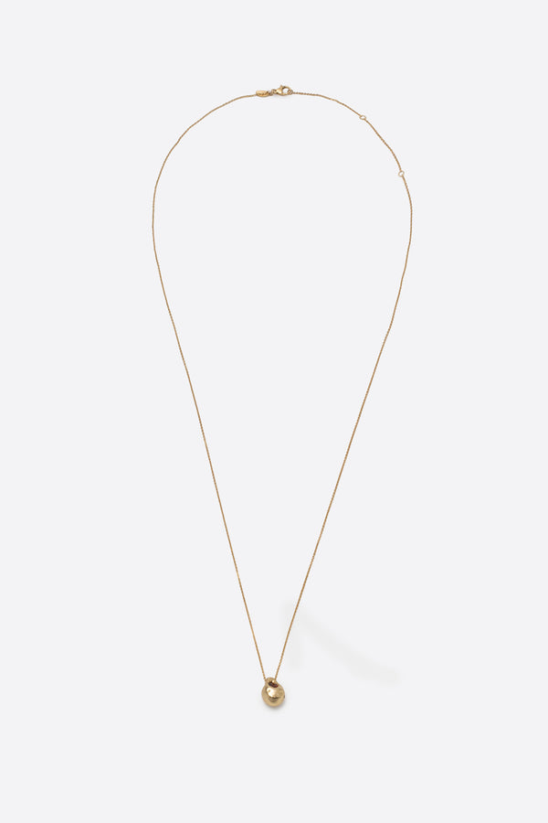 Long gold pendant necklace with sculptural gemstone charm on fine chain
