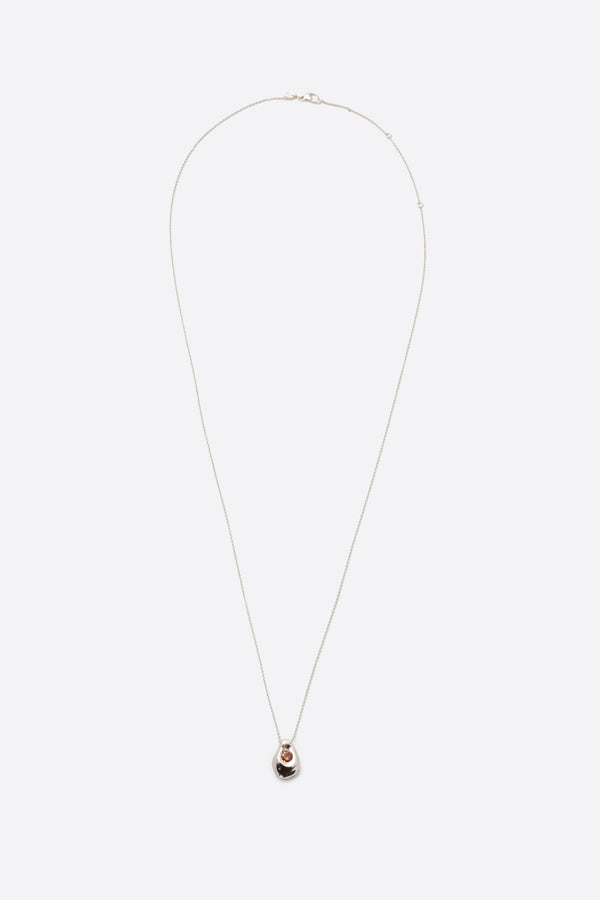 Long silver pendant necklace with sculptural gemstone charm on fine chain