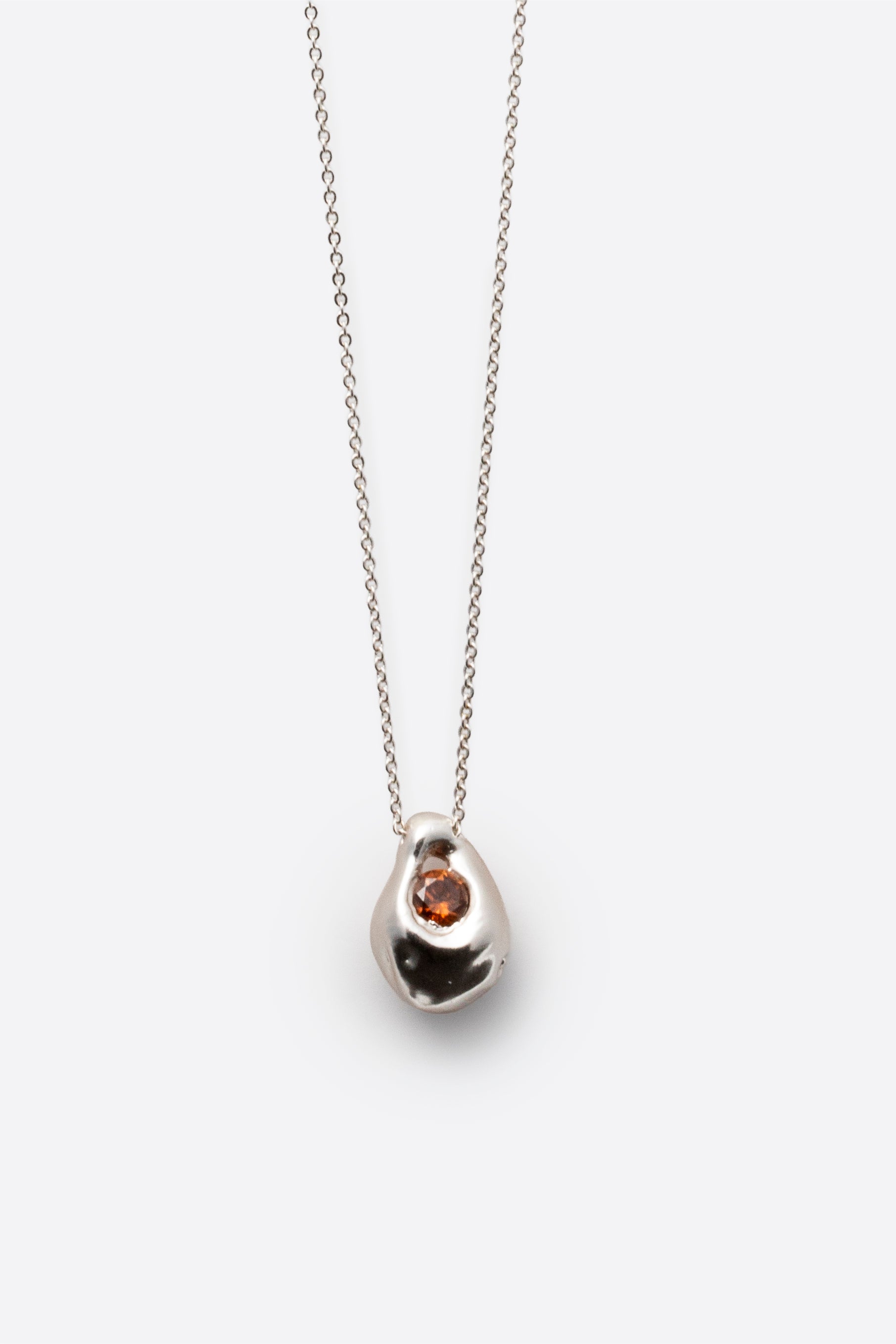 Silver gemstone pendant necklace with organic sculptural pendant