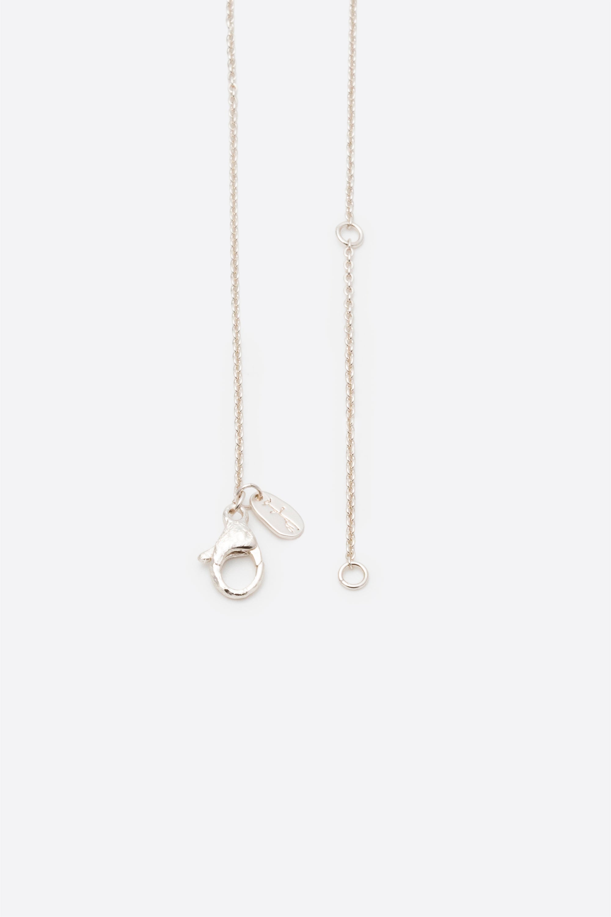 Silver pendant necklace showing adjustable chain and clasp detail