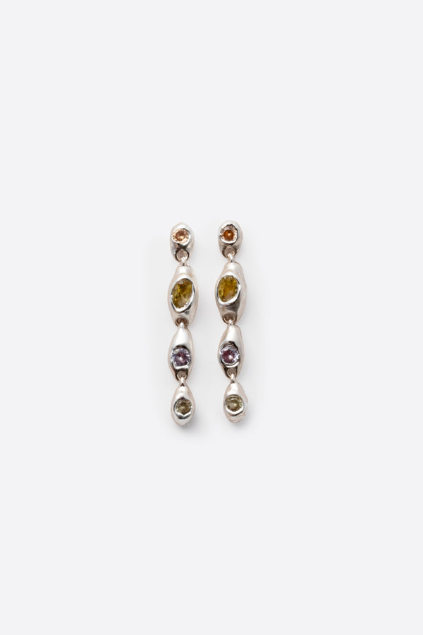Pair of silver earrings with gemstones on a white background