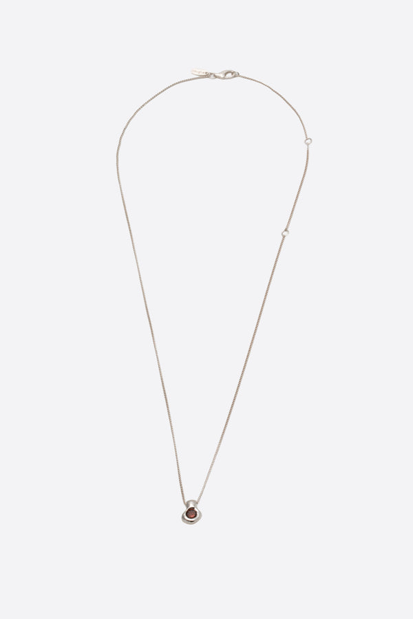 Sculptural silver pendant necklace with dark gemstone on fine chain