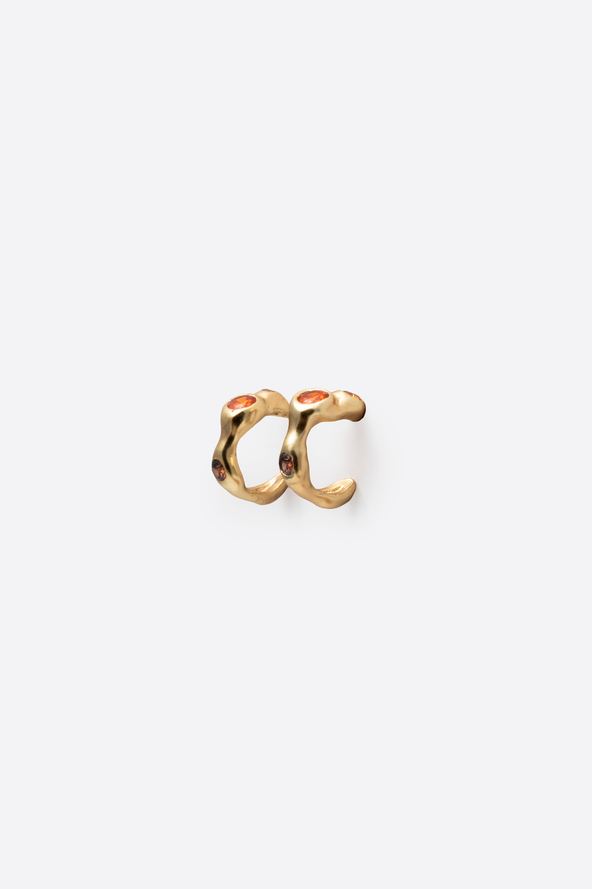 Back view of gold gemstone huggie earrings with sculptural design
