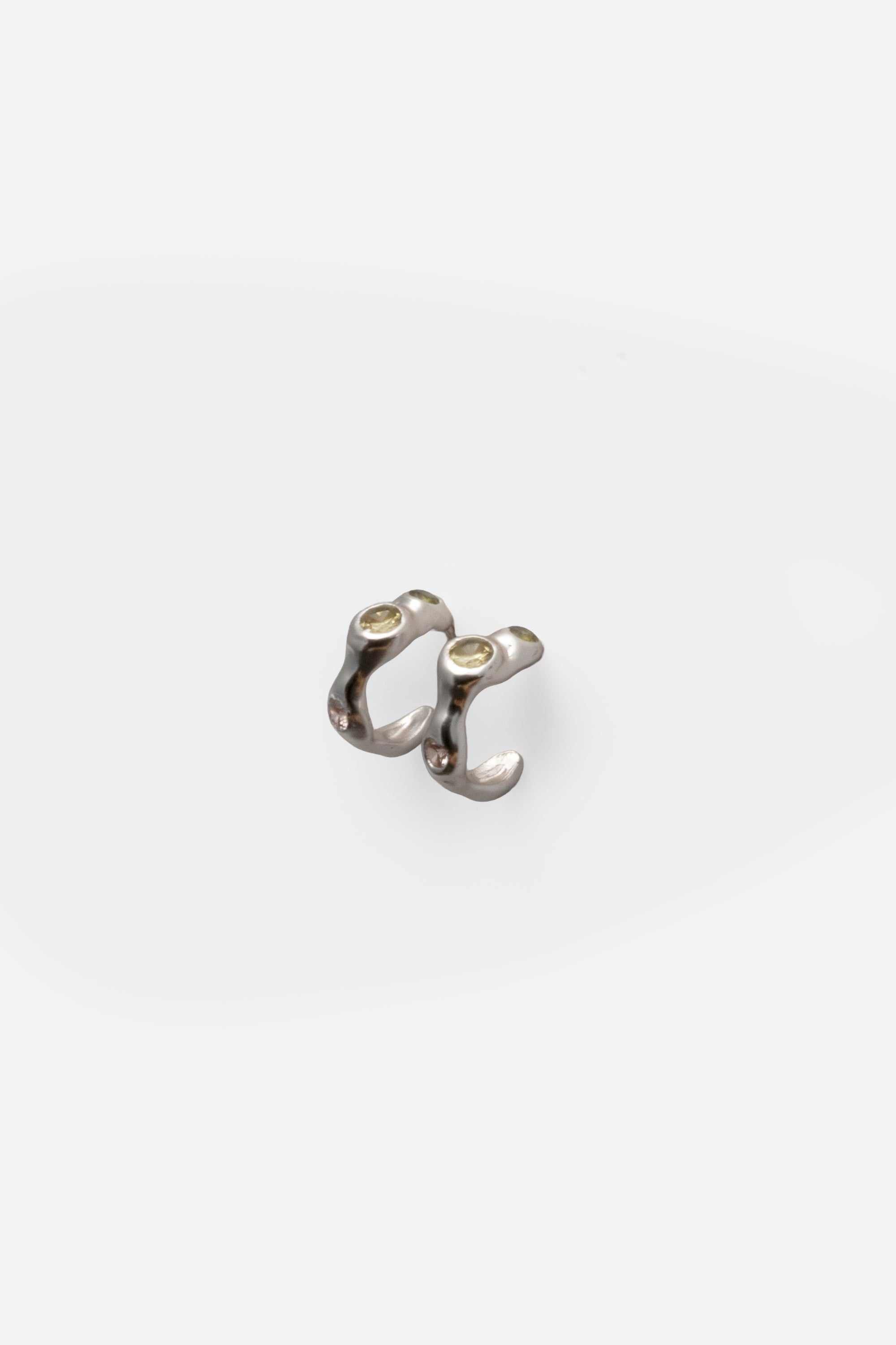 Back view of sterling silver gemstone huggie earrings with organic design