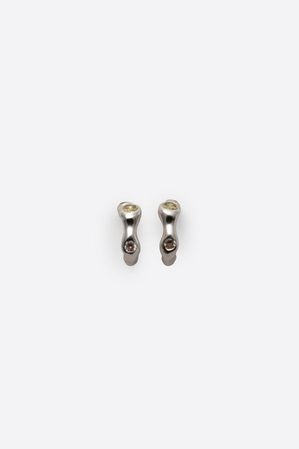 Sculptural sterling silver gemstone huggie earrings on white background