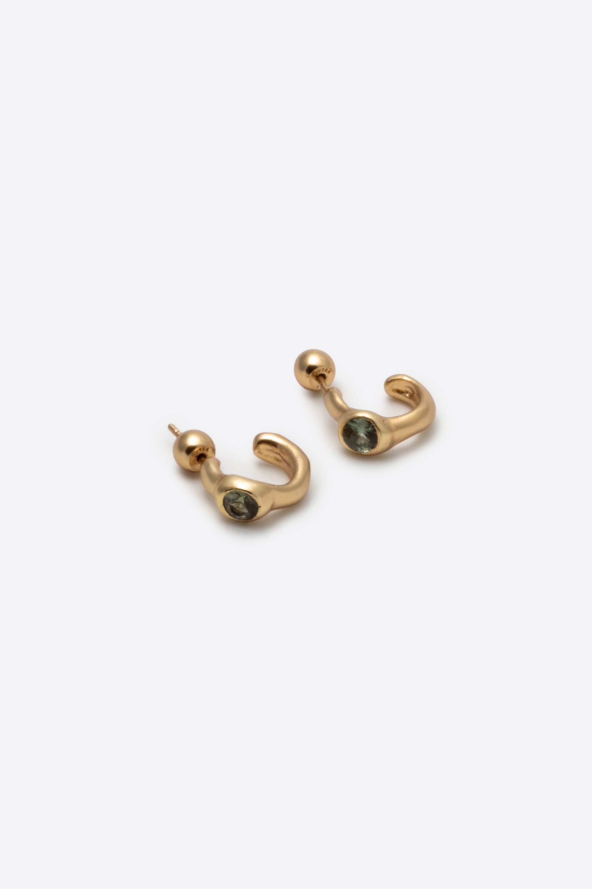 Side view of sculptural gold gemstone stud earrings