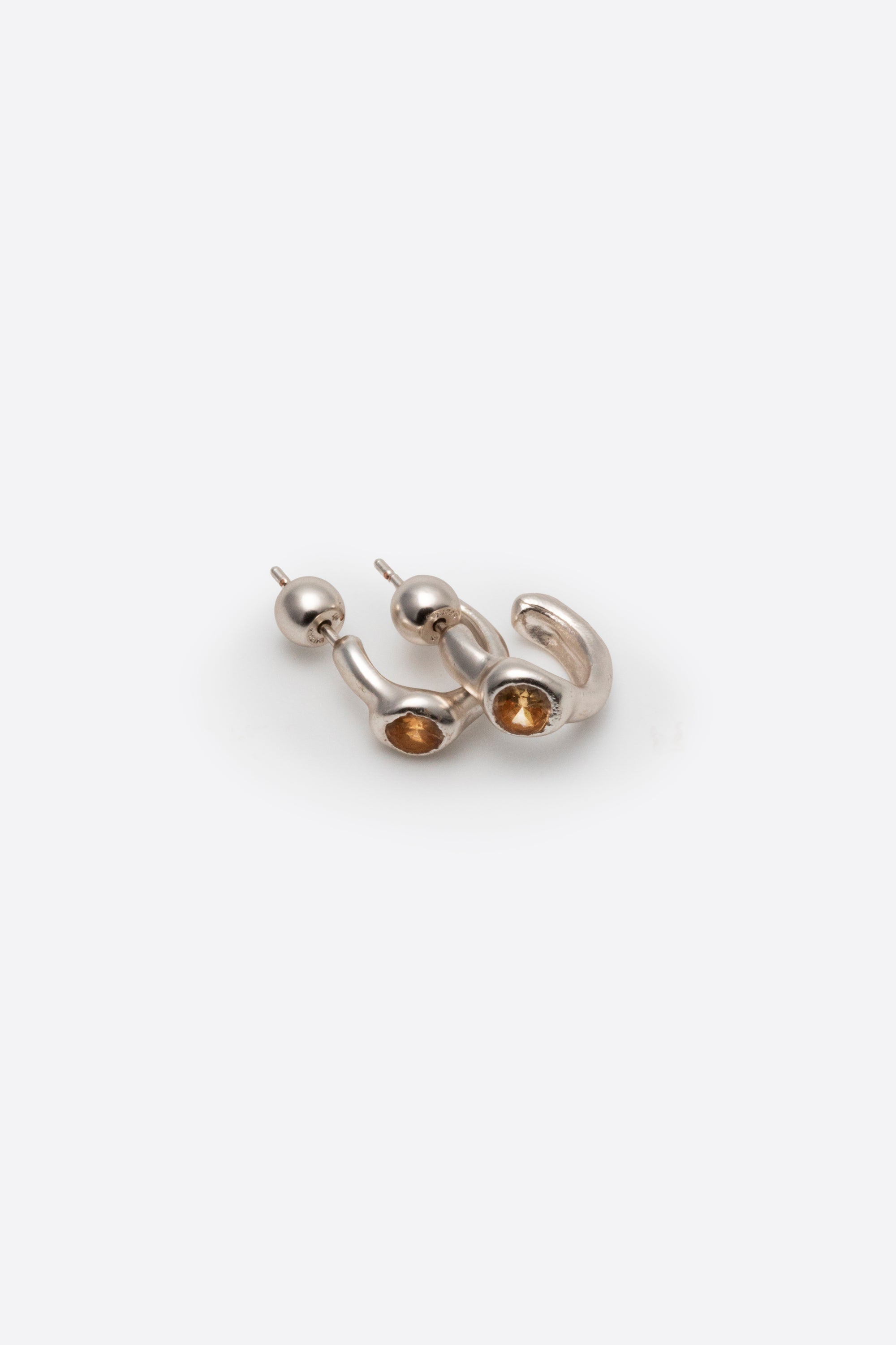 Side view of sculptural sterling silver gemstone stud earrings