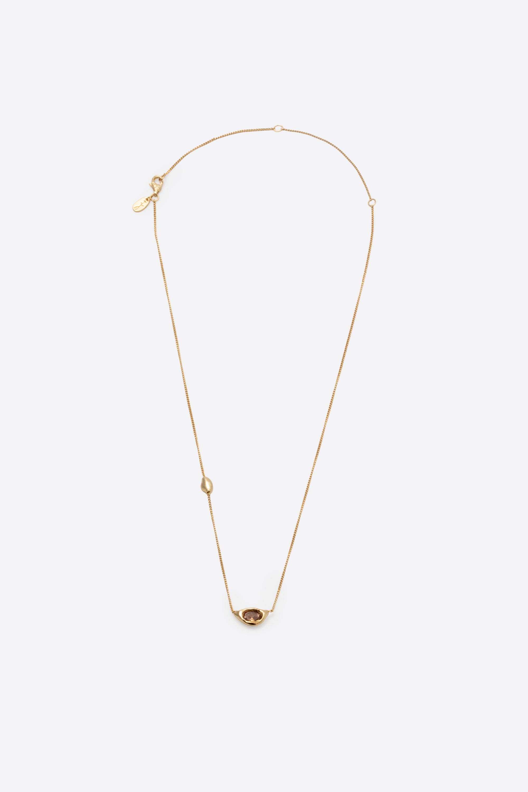 Gold gemstone pendant necklace with sculptural organic pendant